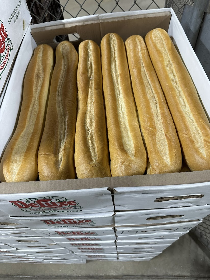 Fresh Italian hoagie rolls on bakery racks